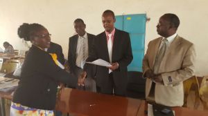 Hon MP Kisoi issuing Bursary cheques on Thursday, 22nd October 2015 at Tawa, Mbooni Constituency. 